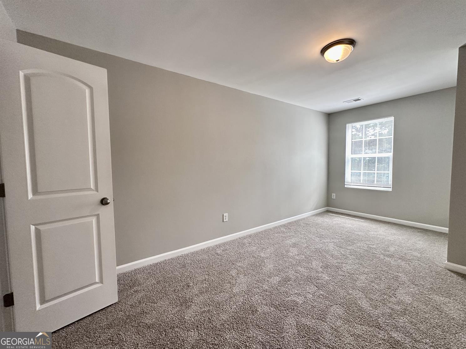 308 Reedell Way Villa Rica, GA 30180 - Photo 13 of 16 an empty room with windows and closet