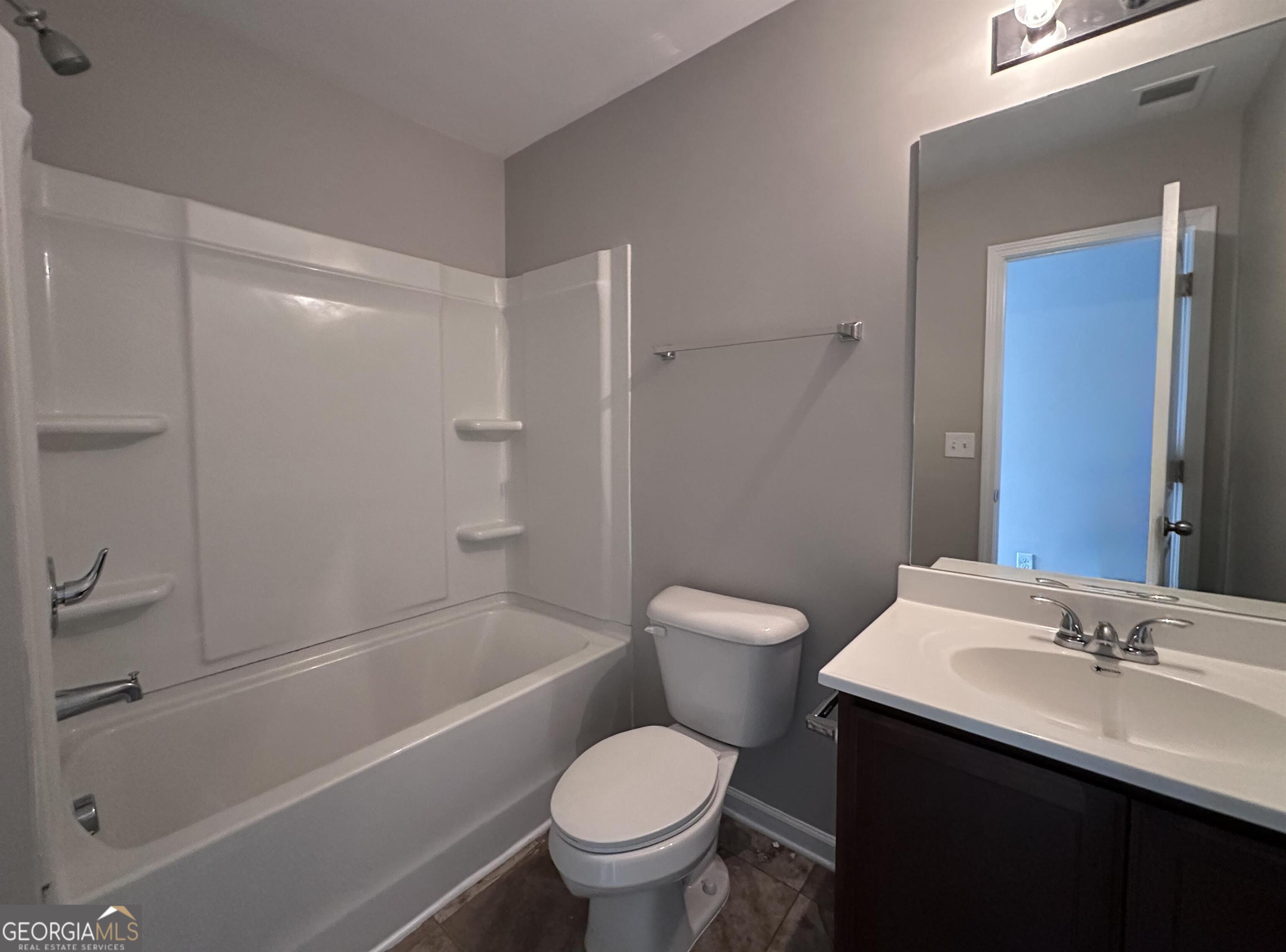 308 Reedell Way Villa Rica, GA 30180 - Photo 15 of 16 a bathroom with a sink toilet and shower