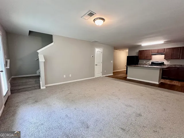 a view of a kitchen with a sink and a stove top oven