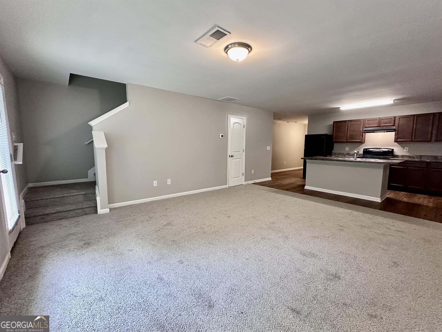 308 Reedell Way Villa Rica, GA 30180 - Photo 3 of 16 a view of a kitchen with a sink and a stove top oven