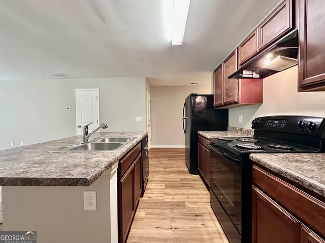 a kitchen with a stove and a sink
