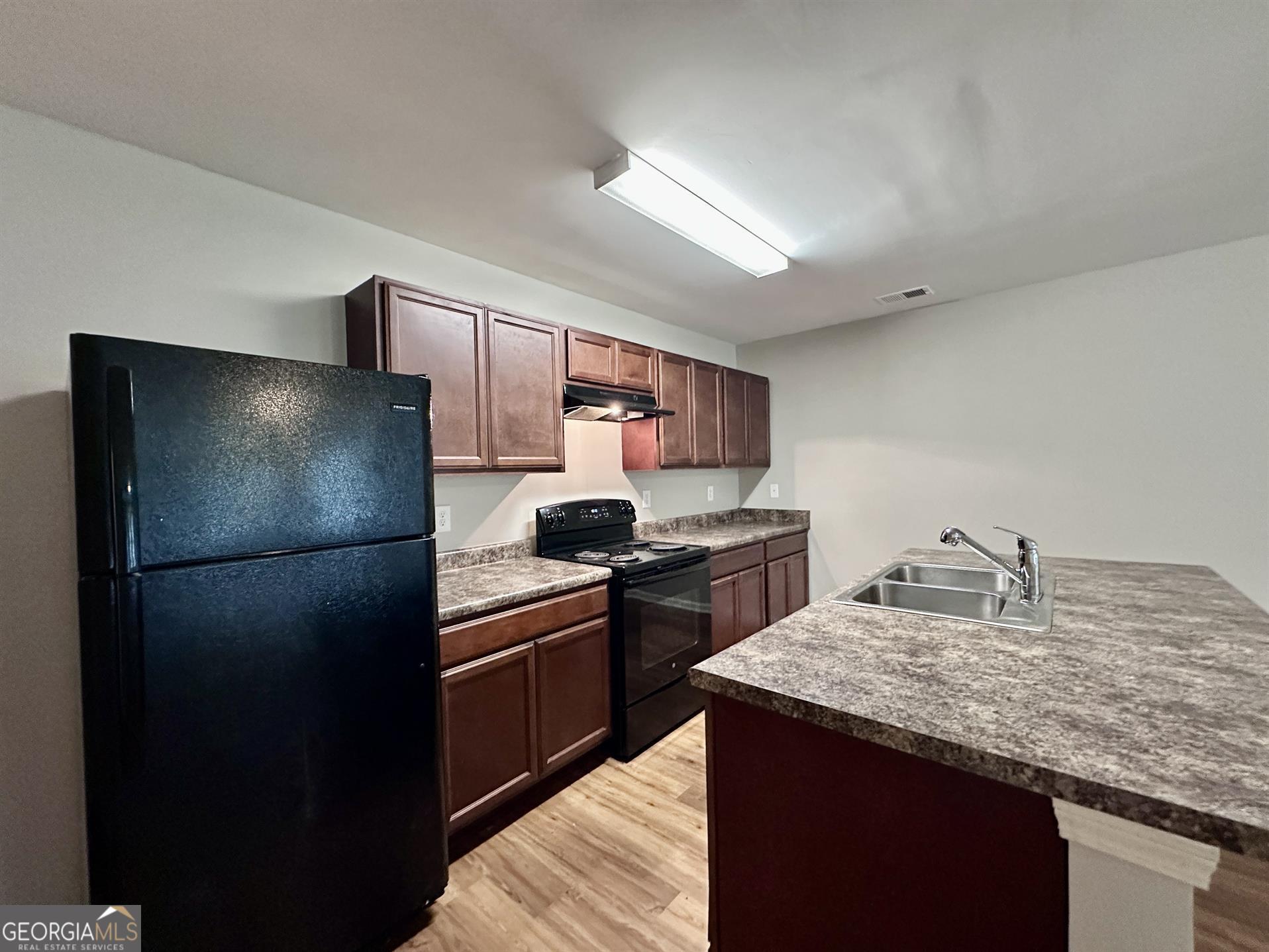 308 Reedell Way Villa Rica, GA 30180 - Photo 5 of 16 a kitchen with granite countertop a refrigerator stove and sink