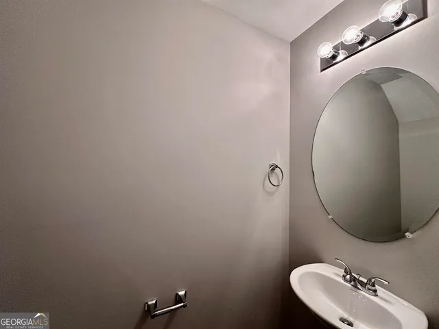 a bathroom with a sink mirror and toilet
