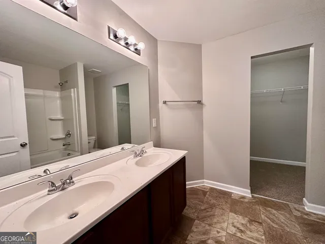 a bathroom with a double vanity sink a and mirror