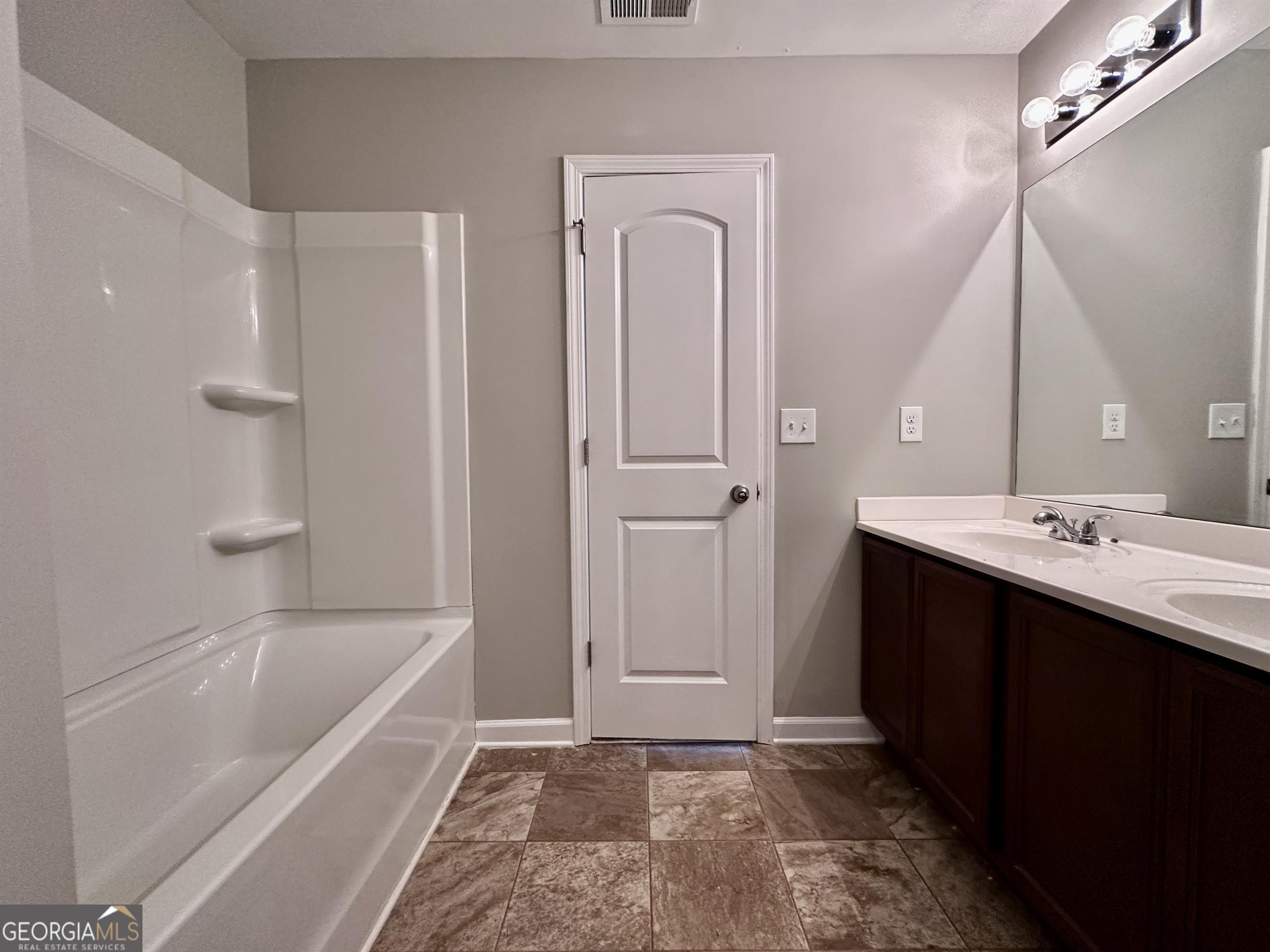 308 Reedell Way Villa Rica, GA 30180 - Photo 10 of 16 a bathroom with a tub sink shower and mirror
