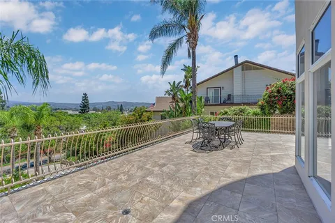 a view of a chairs and table in patio with wooden fence