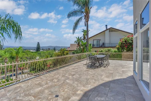 a view of a chairs and table in patio with wooden fence