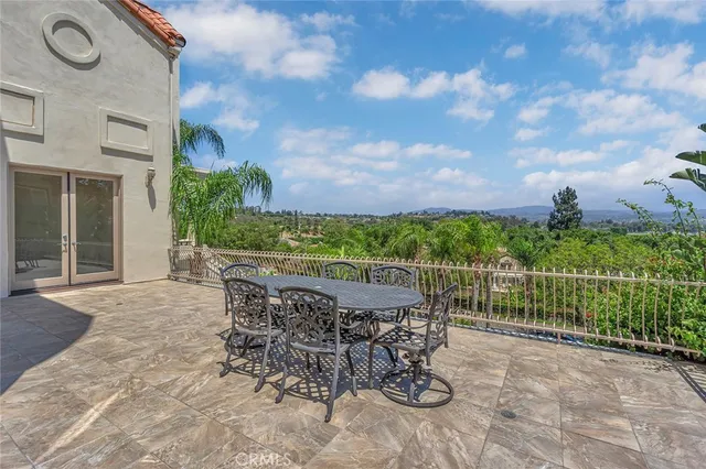 a view of a patio with a table and chairs