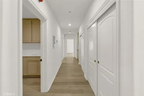 a view of a hallway with wooden floor and staircase