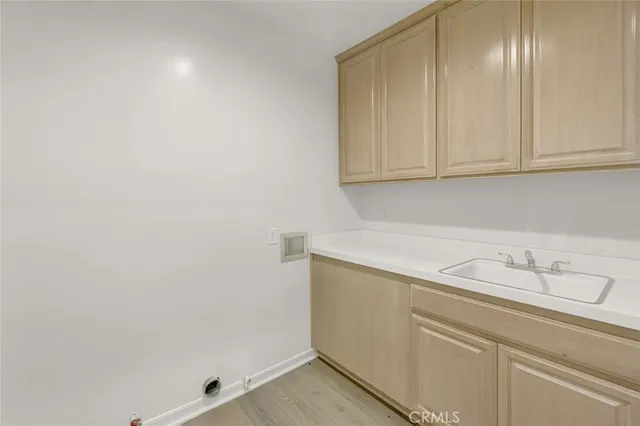 a view of storage and utility room with cabinets