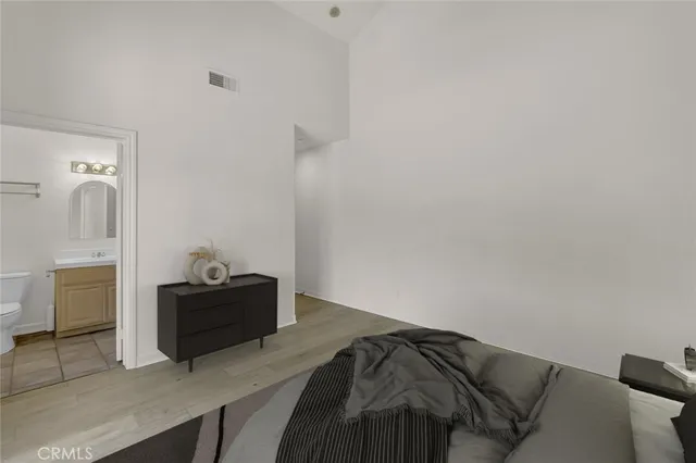 a bedroom with a bed and a mirror