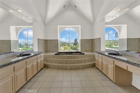 a kitchen with stainless steel appliances granite countertop a stove a sink and a wooden floors