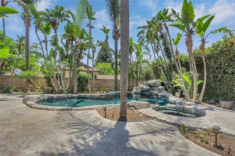 a backyard of a house with a garden and outdoor seating