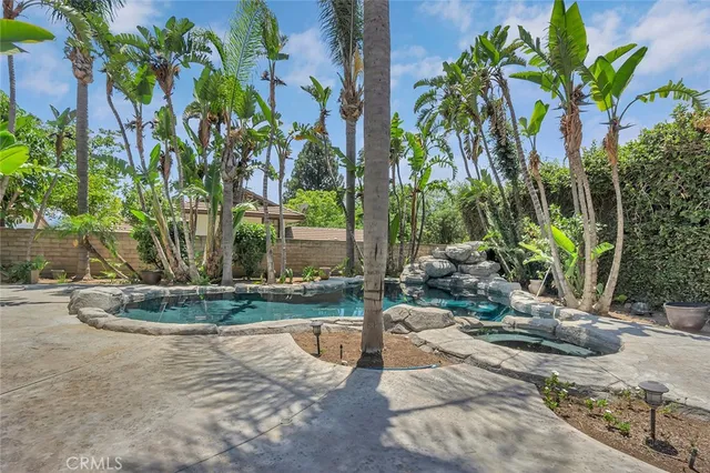a backyard of a house with a garden and outdoor seating