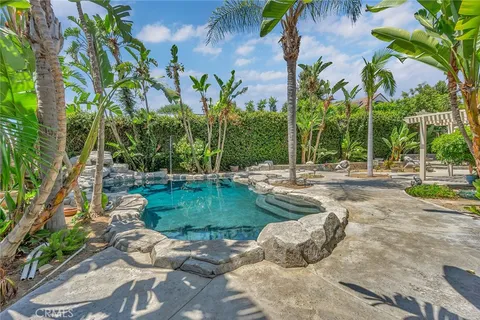 a view of a house with a yard and sitting area