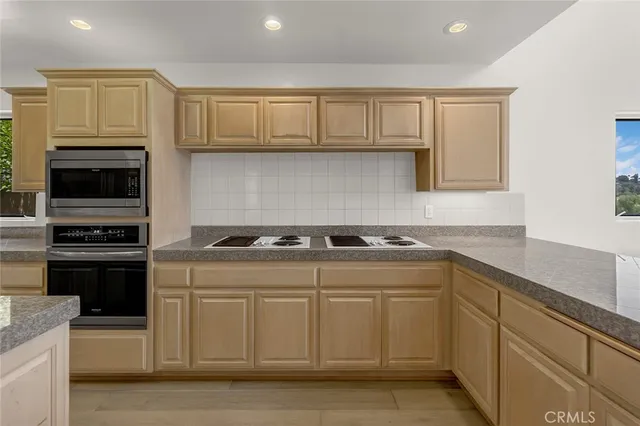 a kitchen with cabinets appliances and a sink