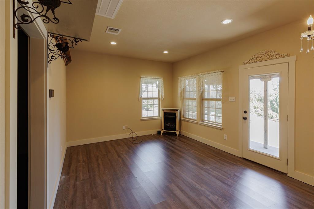 1433 County Road 1180 Decatur, TX 76234 - Photo 28 of 36 a view of an empty room with a window and wooden floor