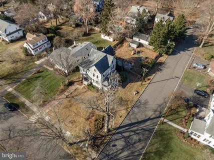 an aerial view of a house with a yard and mountain view in back