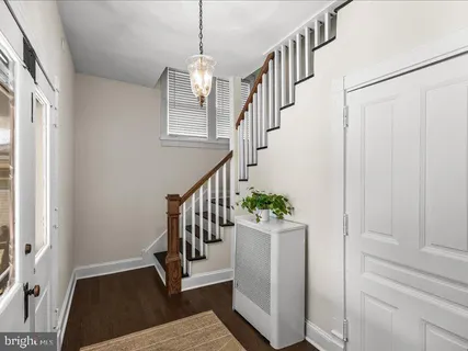 a view of entryway with wooden floor and stairs