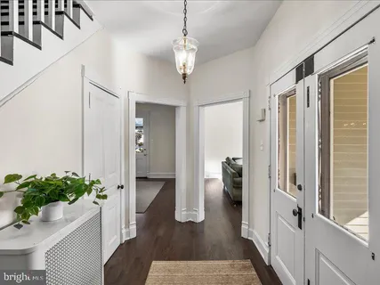 a hallway with wooden floor and windows