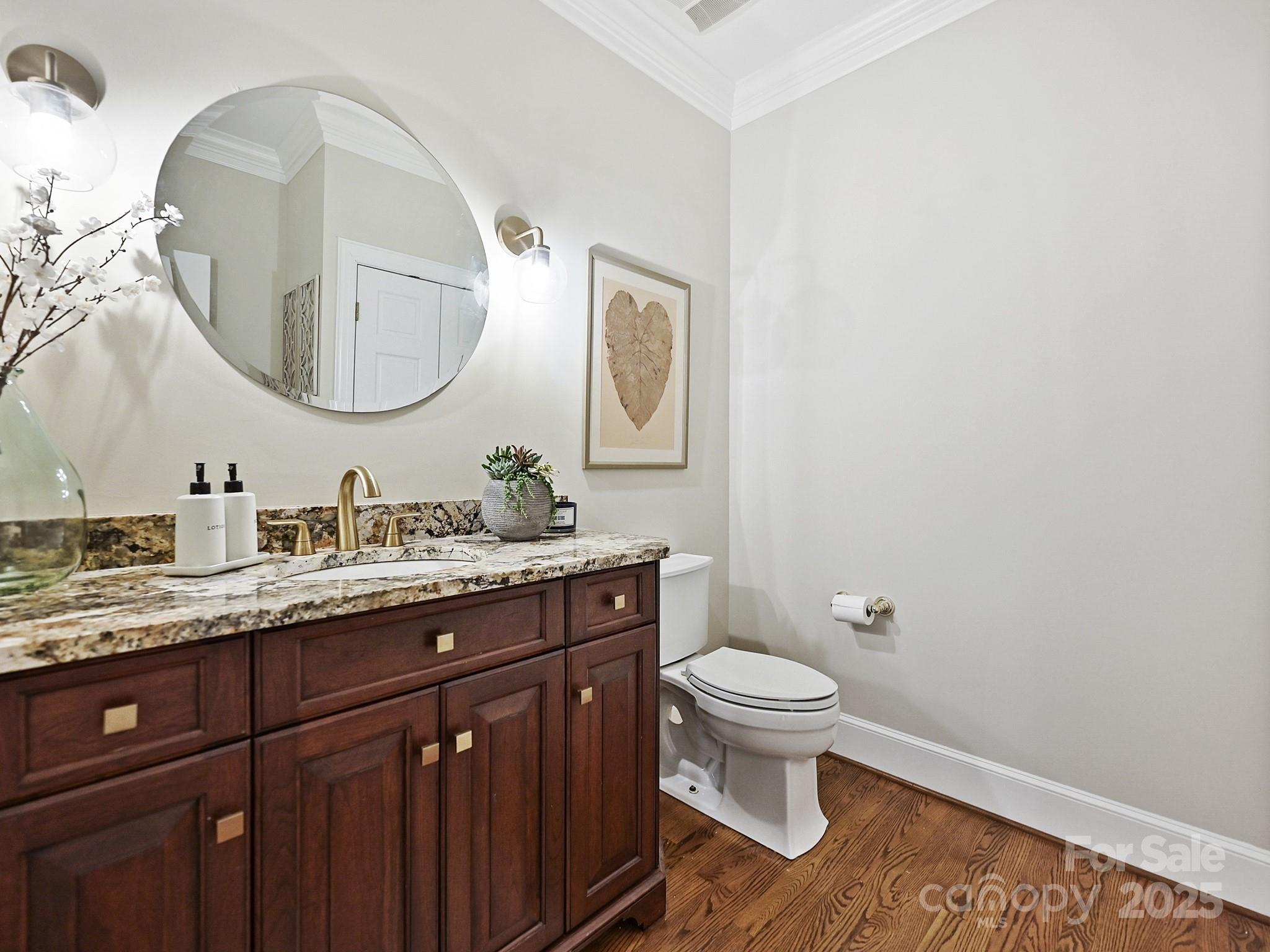 3915 Ayscough Road Charlotte, NC 28211 - Photo 21 of 45 a bathroom with a granite countertop toilet a sink and a mirror