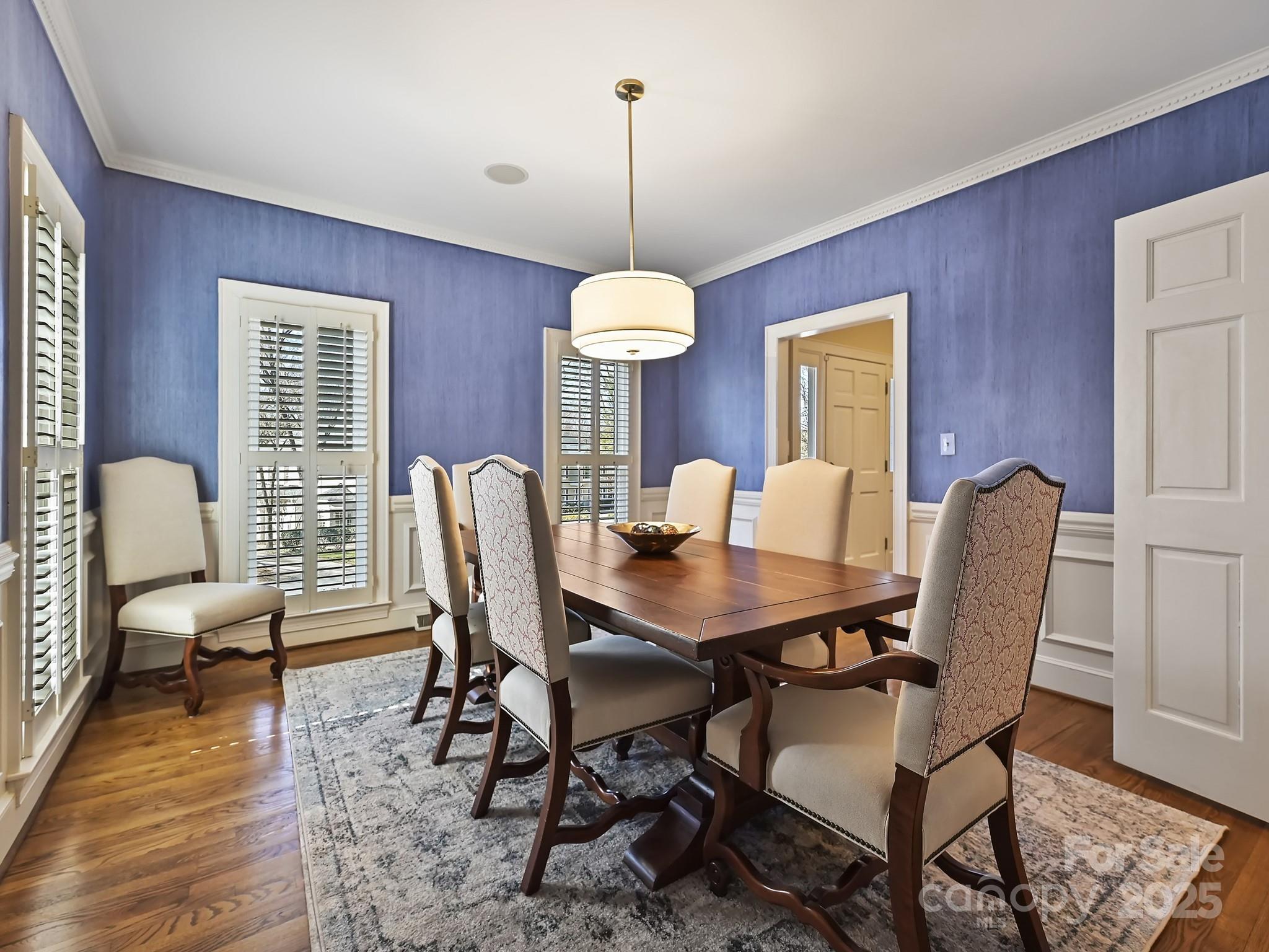 3915 Ayscough Road Charlotte, NC 28211 - Photo 6 of 45 a dining room with furniture a chandelier and wooden floor