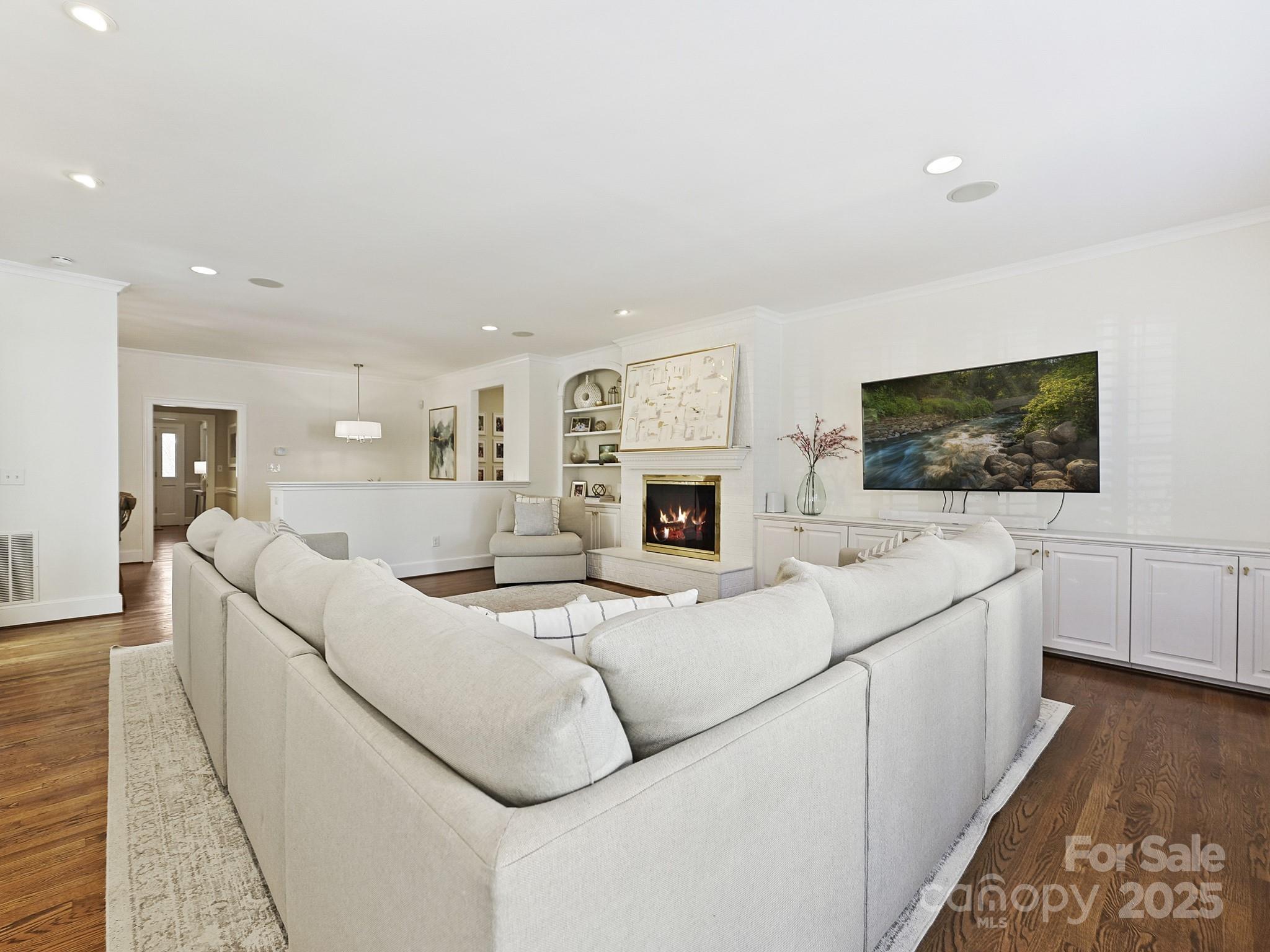 3915 Ayscough Road Charlotte, NC 28211 - Photo 10 of 45 a living room with furniture a flat screen tv and a fireplace