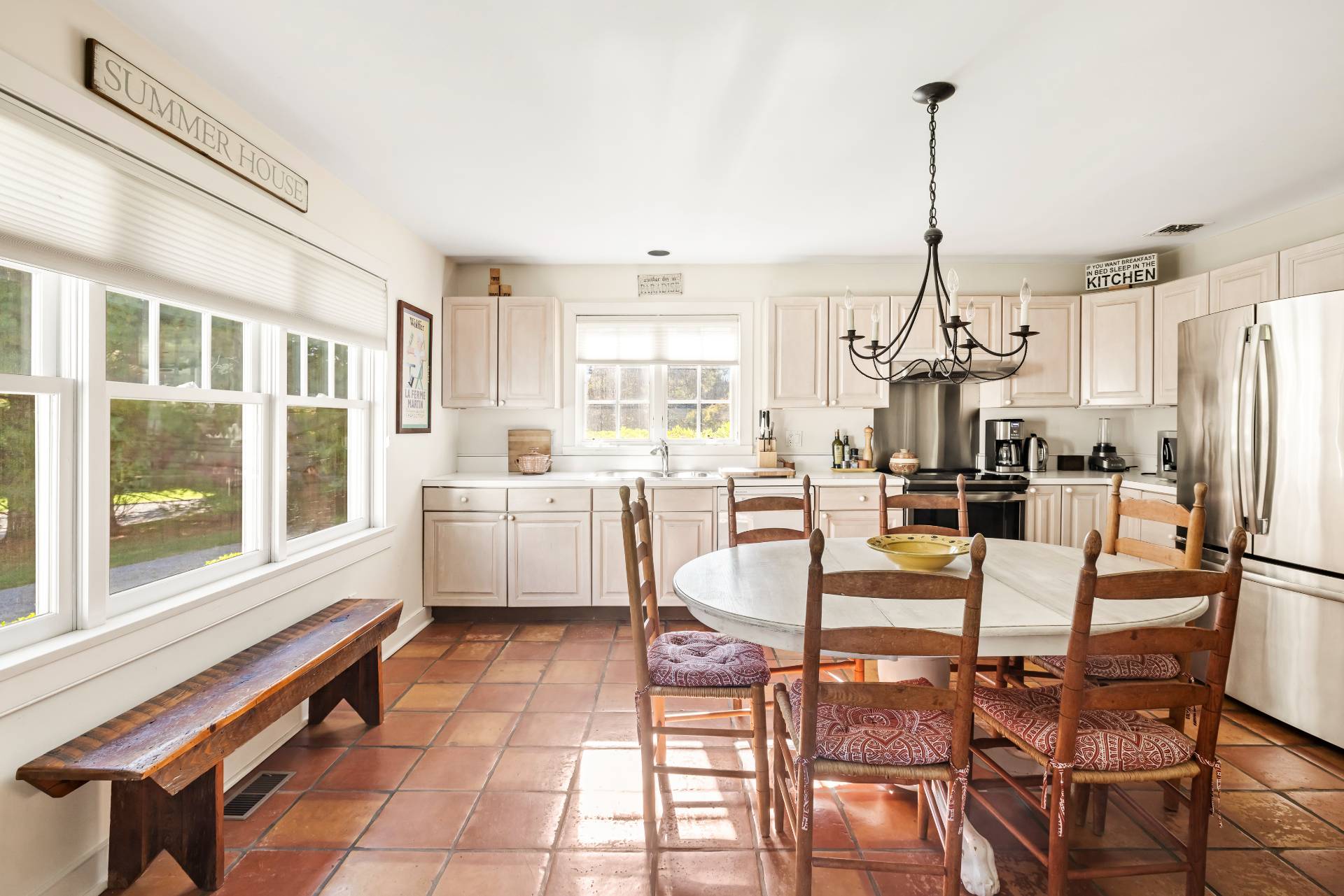 10 Aelfie's Way Bridgehampton, NY 11932 - Photo 12 of 23 a kitchen with stainless steel appliances a stove a table and chairs