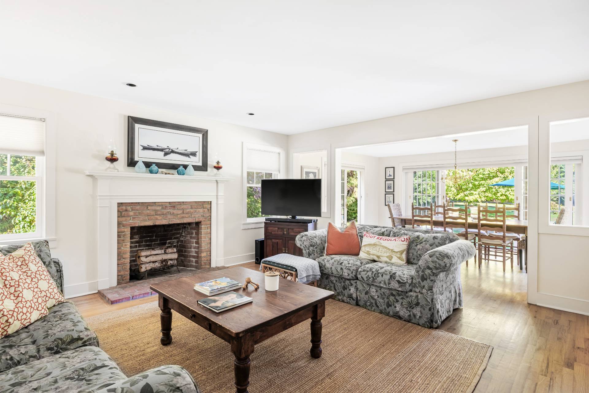 10 Aelfie's Way Bridgehampton, NY 11932 - Photo 10 of 23 a living room with furniture a fireplace a flat screen tv and a large window