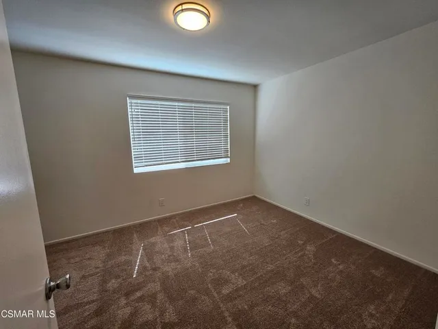 a bathroom with a granite countertop sink toilet a mirror and shower