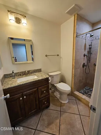 a bathroom with a shower and a sink