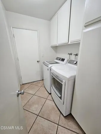 a view of a patio with table and chairs and wooden fence