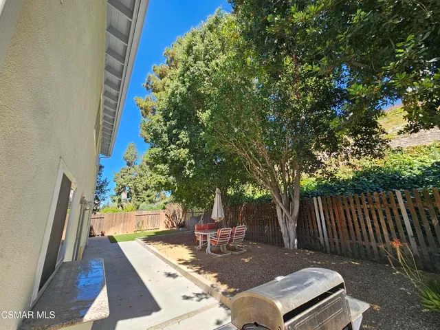 a view of a backyard with swimming pool