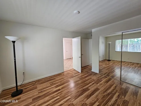 a view of a room with wooden floor