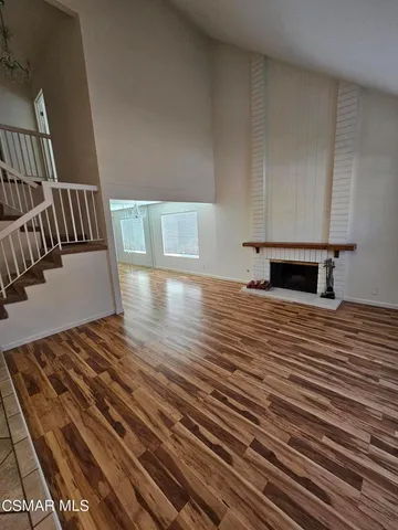 a view of a room with wooden floor