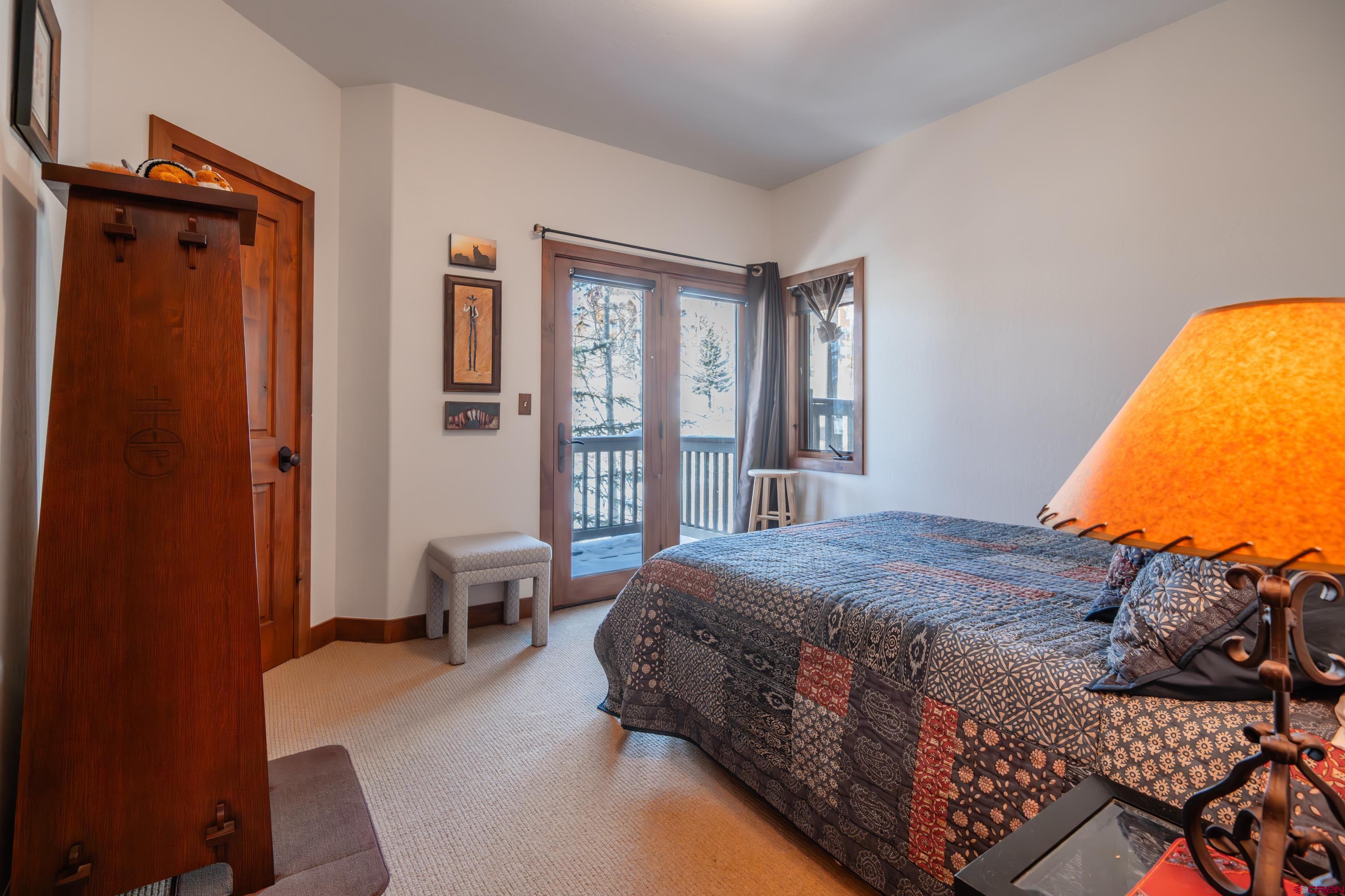 11 Castle Road Crested Butte, CO 81225 - Photo 12 of 45 a bedroom with a bed and wooden floor