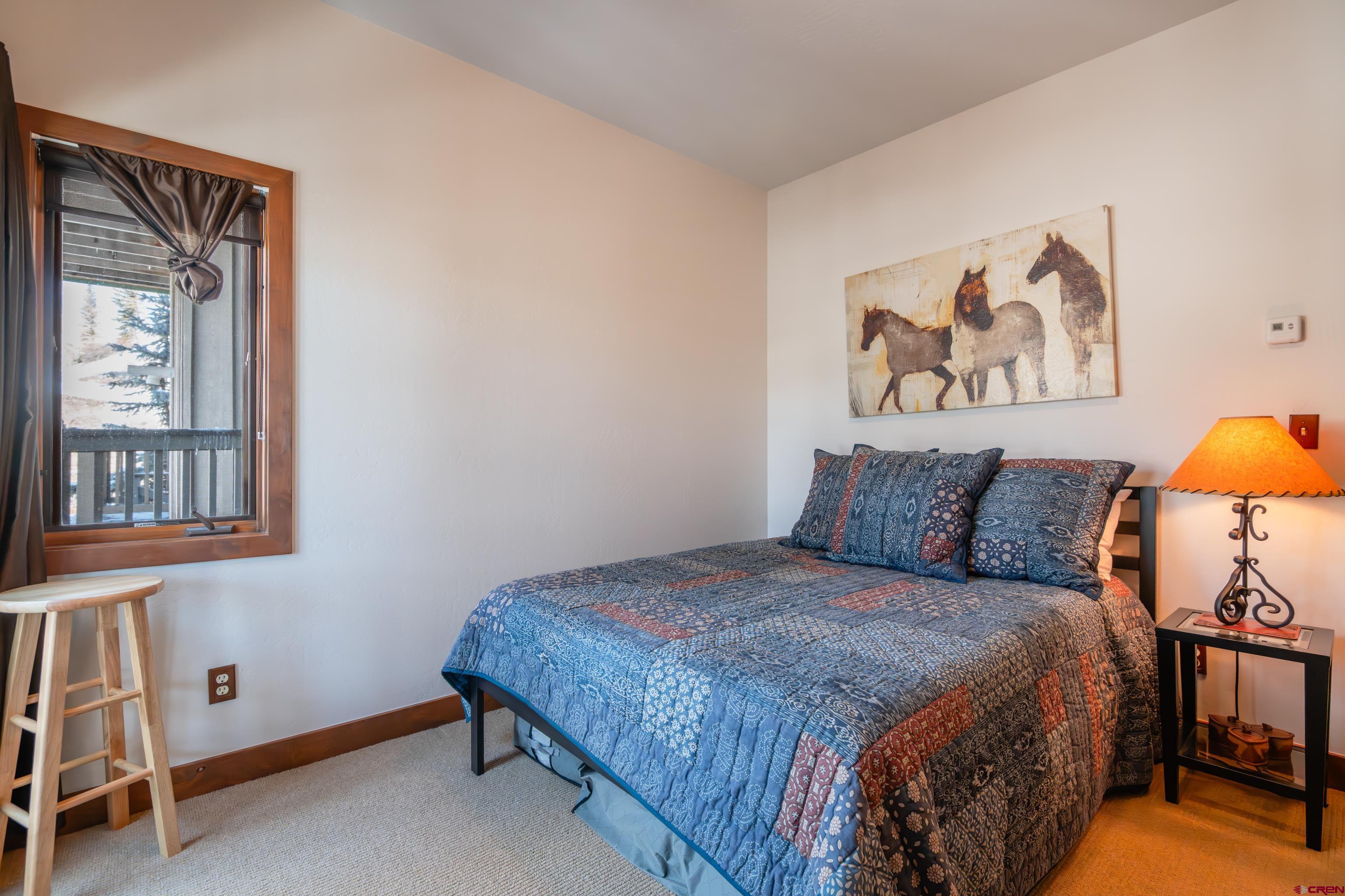 11 Castle Road Crested Butte, CO 81225 - Photo 13 of 45 a bedroom with a bed and a window