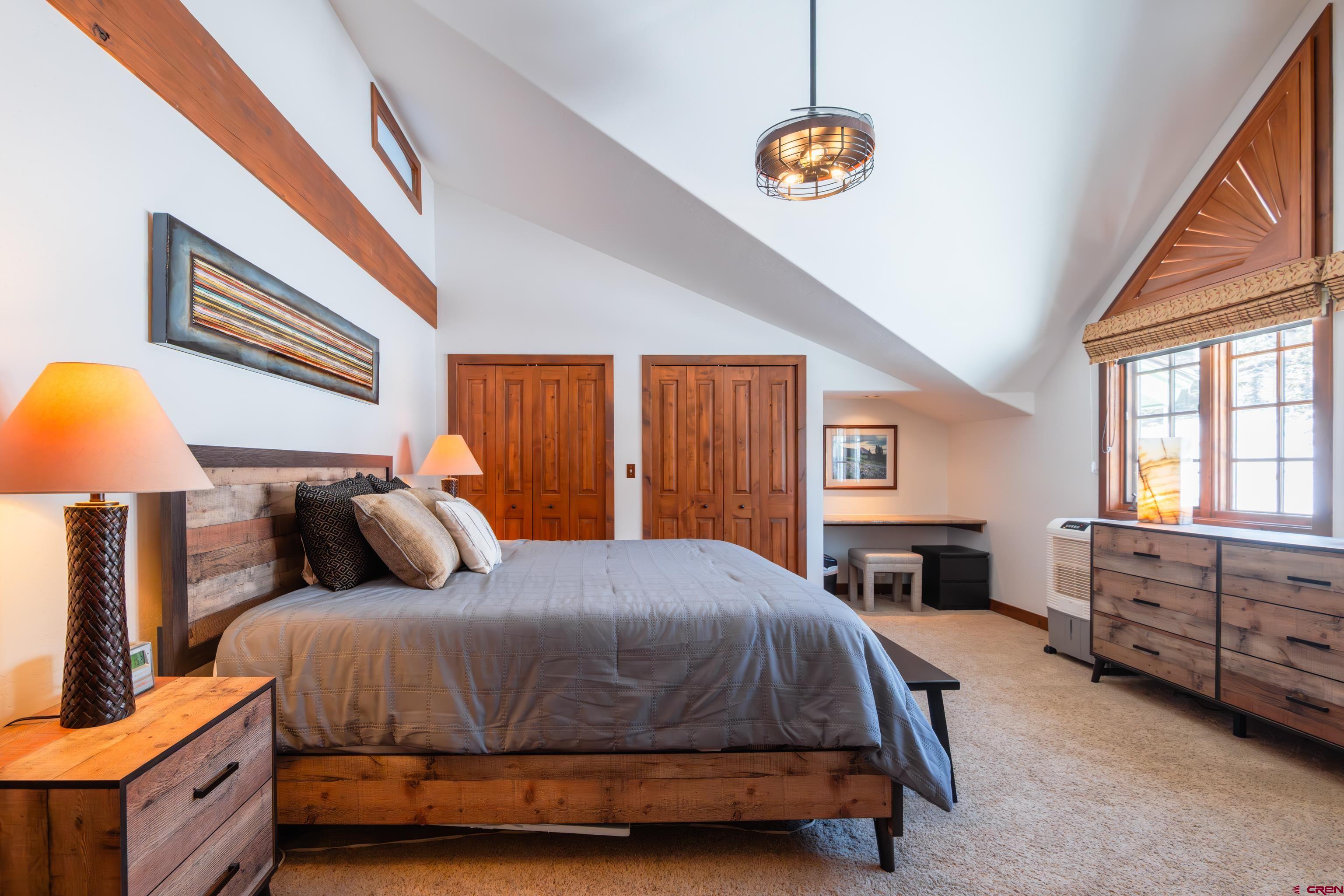 11 Castle Road Crested Butte, CO 81225 - Photo 16 of 45 a bedroom with a bed and a chandelier