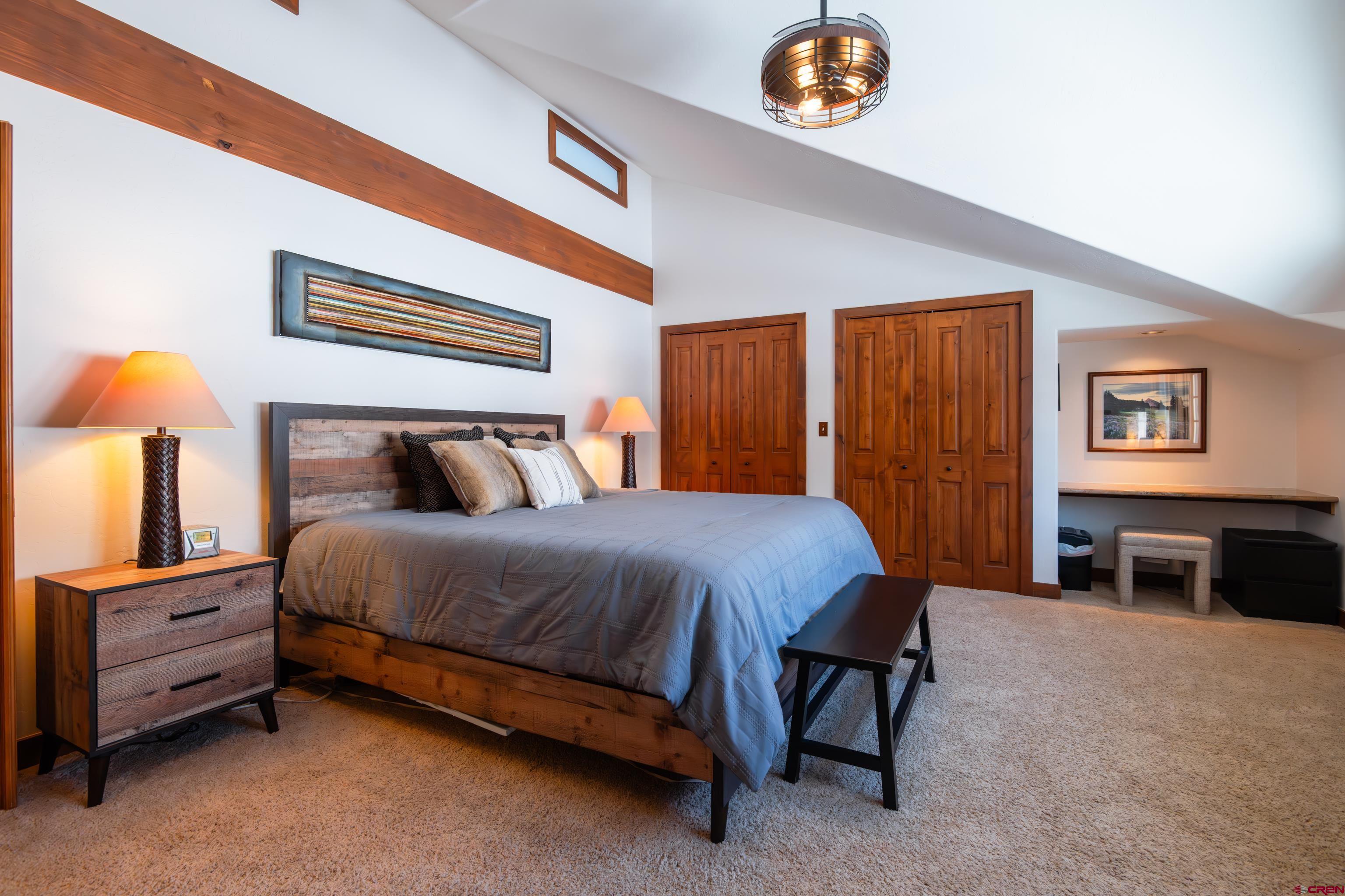 11 Castle Road Crested Butte, CO 81225 - Photo 18 of 45 a bedroom with a bed and a lamp