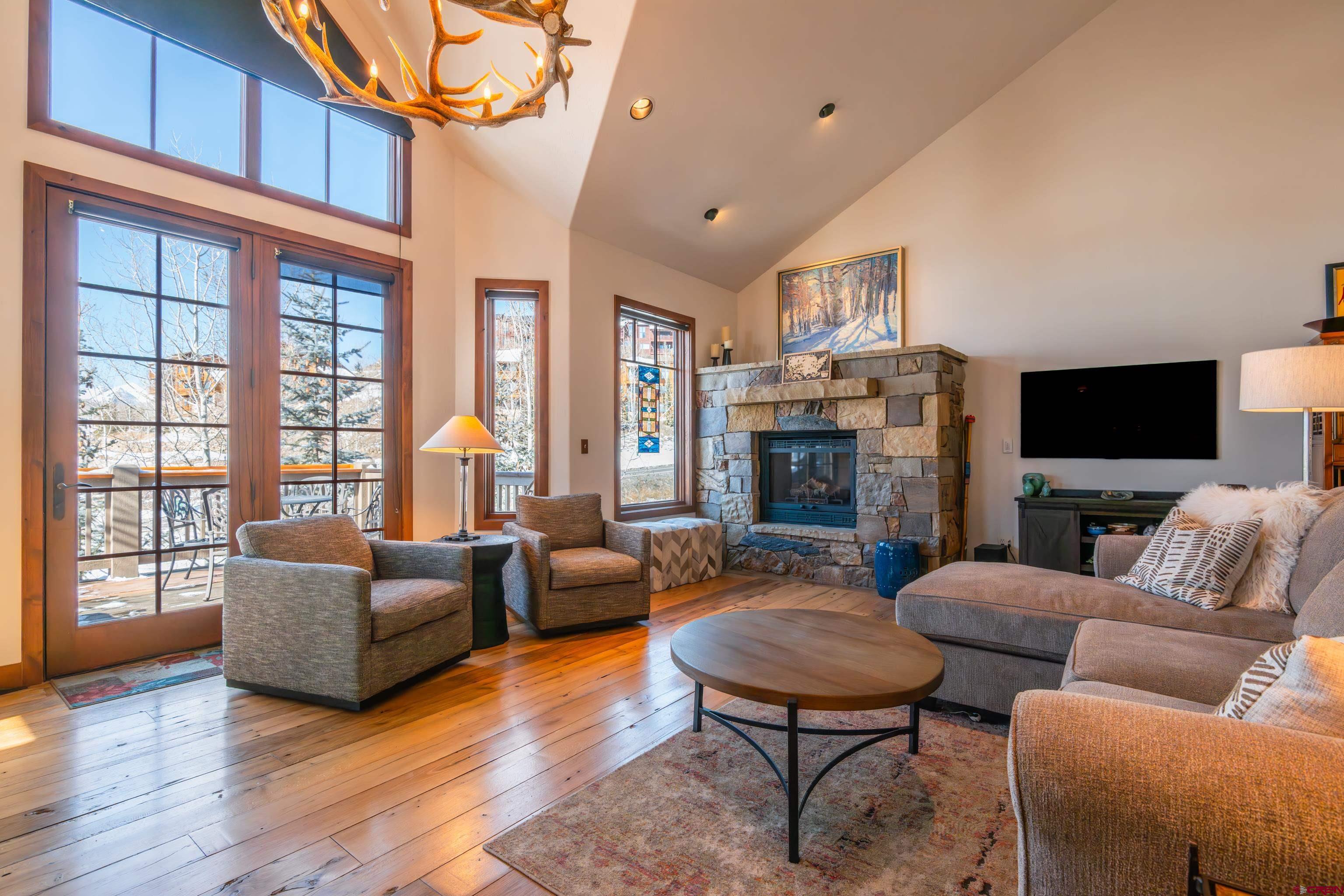 11 Castle Road Crested Butte, CO 81225 - Photo 2 of 45 a living room with fireplace furniture and a flat screen tv