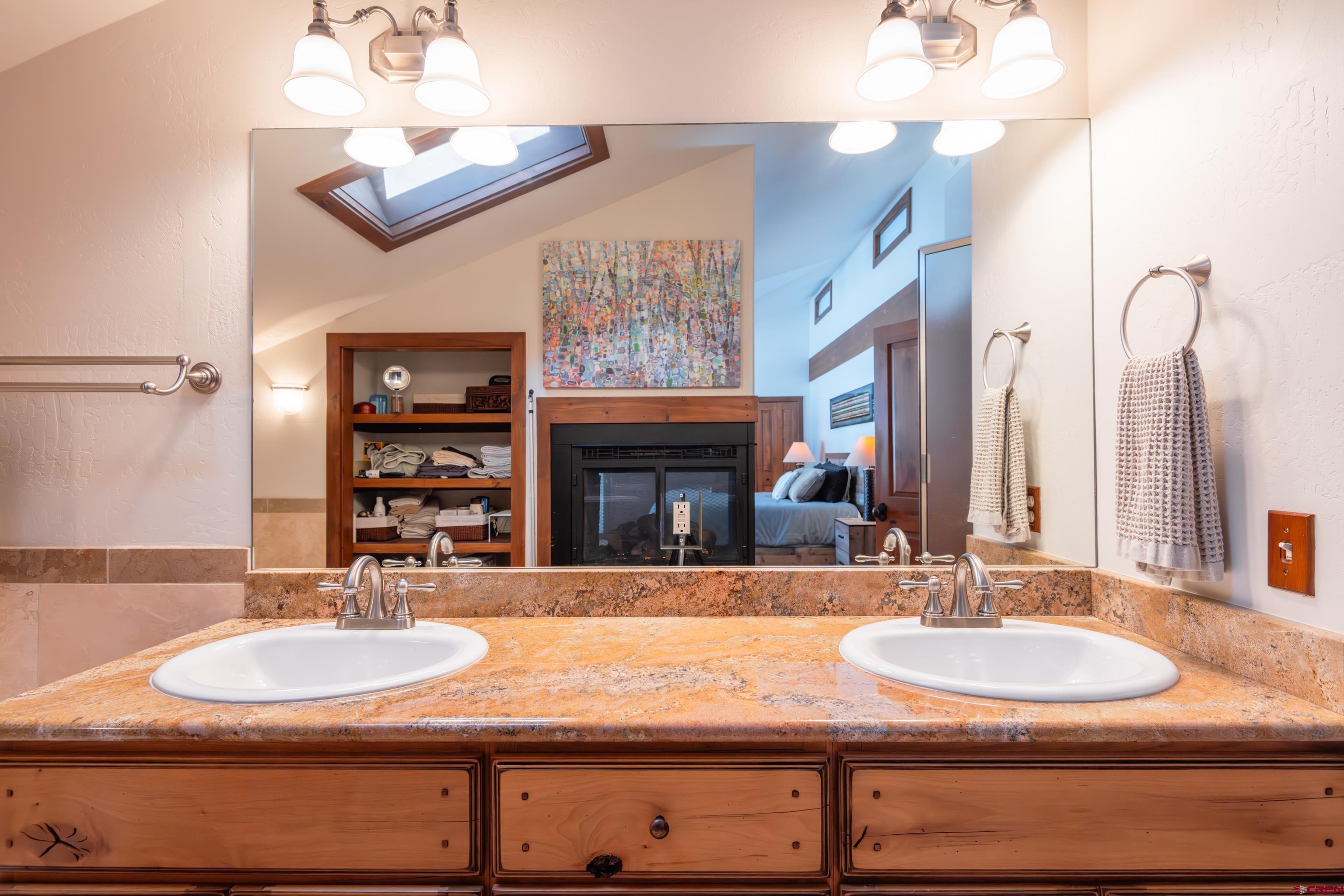 11 Castle Road Crested Butte, CO 81225 - Photo 26 of 45 a bathroom with a granite countertop sink and a mirror