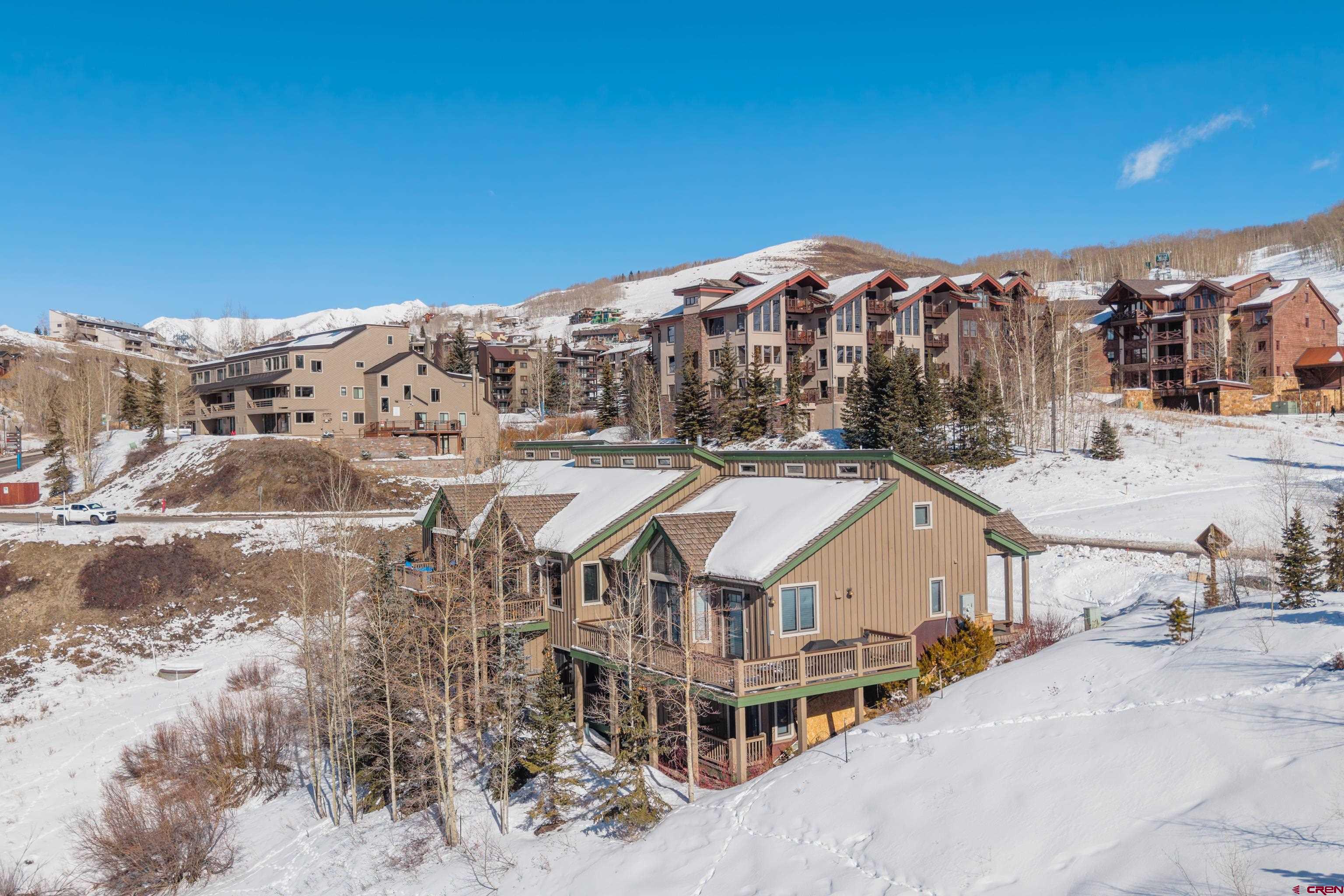 11 Castle Road Crested Butte, CO 81225 - Photo 29 of 45 a view of a big house with a big yard and large trees