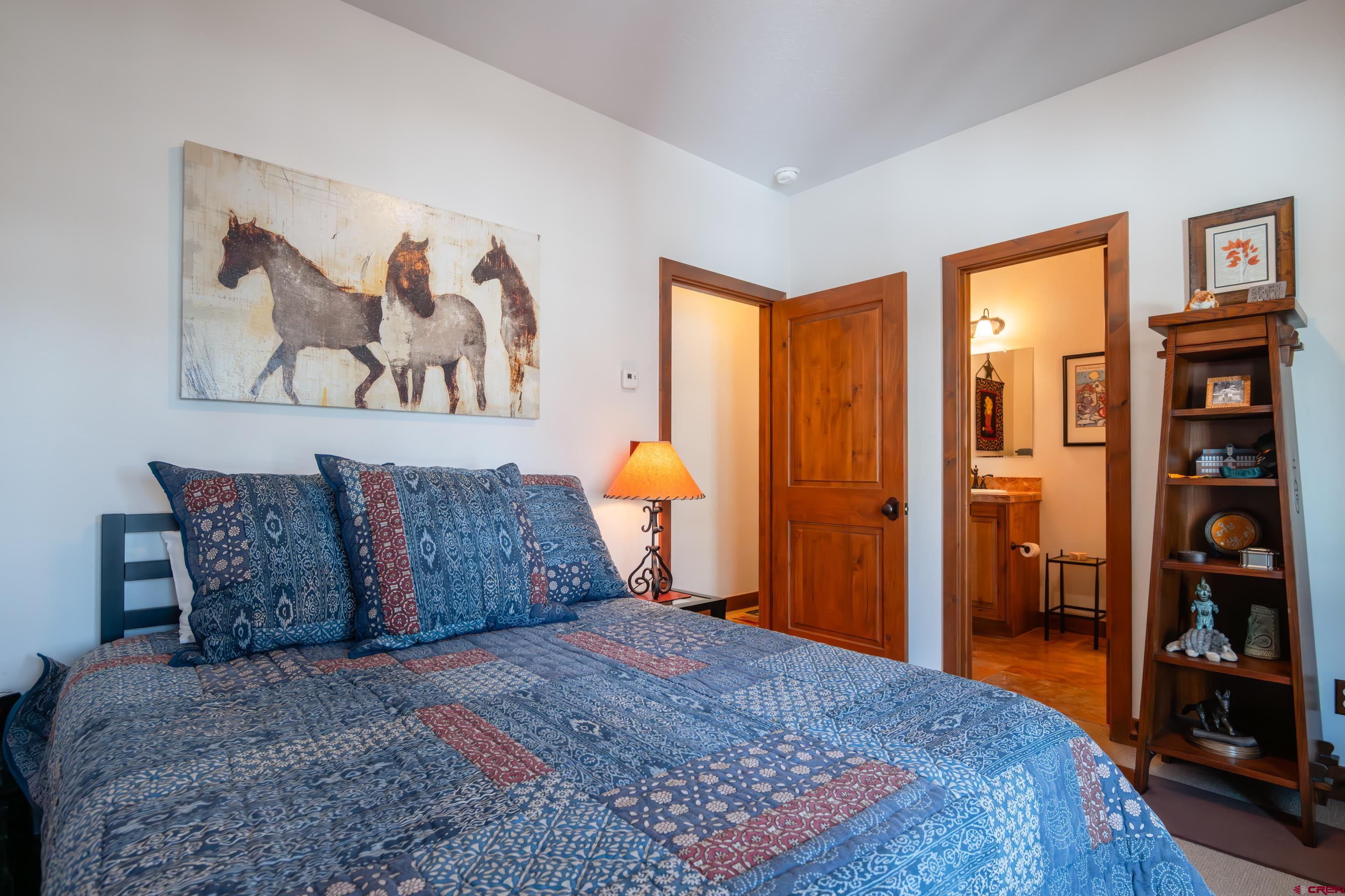 11 Castle Road Crested Butte, CO 81225 - Photo 39 of 45 a bedroom with a large bed and a book shelf