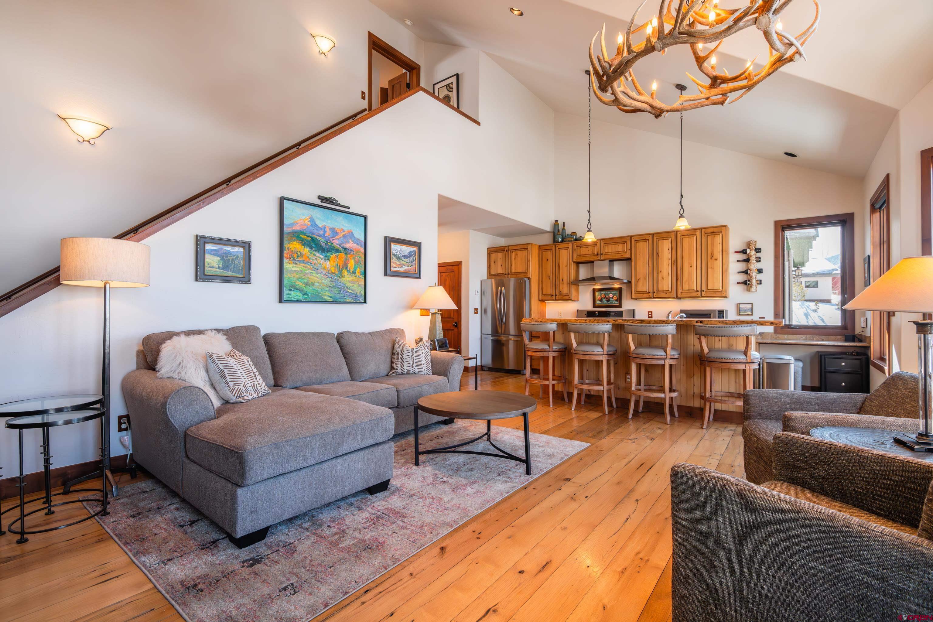 11 Castle Road Crested Butte, CO 81225 - Photo 9 of 45 a living room with furniture kitchen view and a chandelier