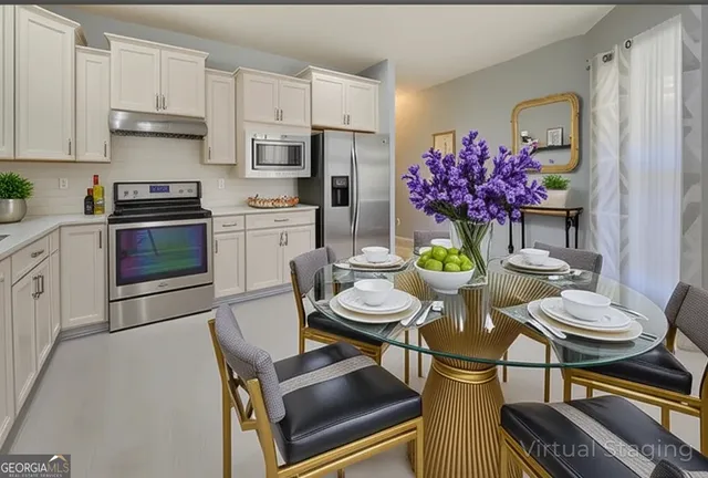 a kitchen with white cabinets and white appliances