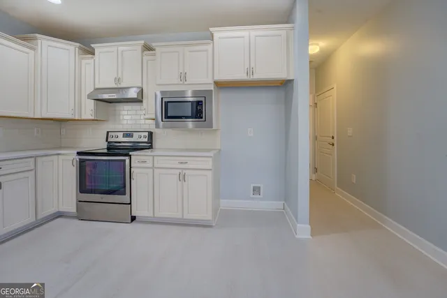 a living room with furniture chandelier and a window