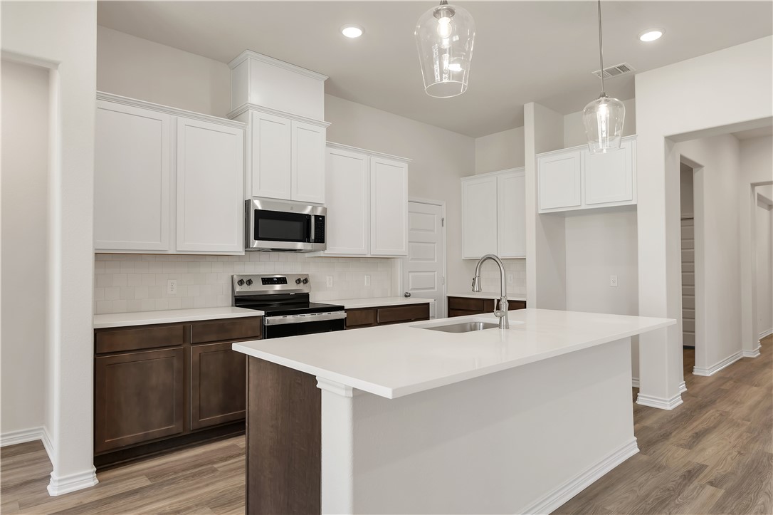 1931 Pinemont View Drive Bryan, TX 77807 - Photo 15 of 43 a kitchen with stainless steel appliances a sink stove and refrigerator