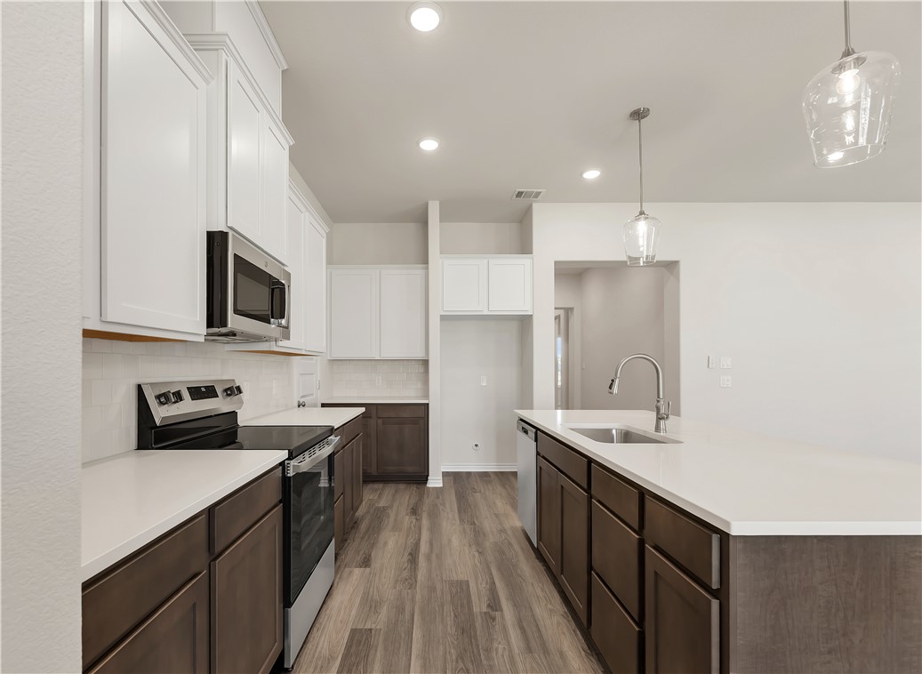 1931 Pinemont View Drive Bryan, TX 77807 - Photo 17 of 43 a kitchen with a sink stove top oven and refrigerator