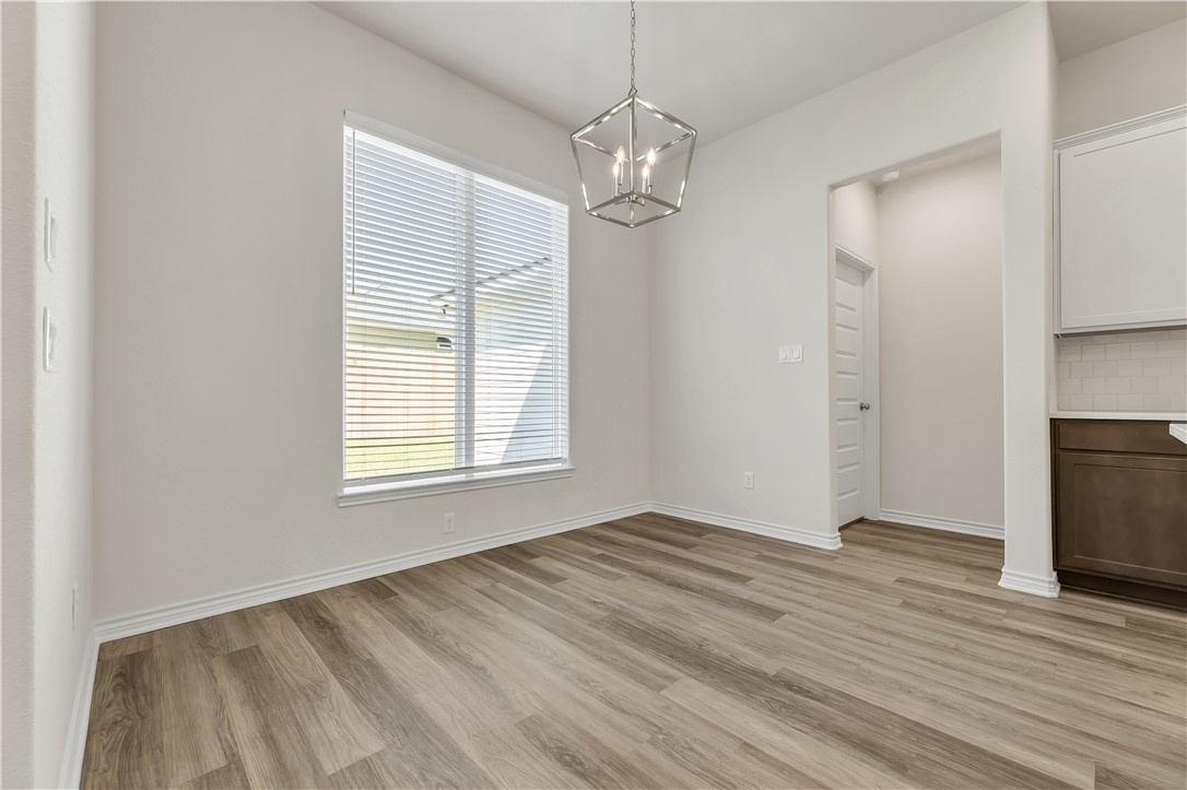1931 Pinemont View Drive Bryan, TX 77807 - Photo 20 of 43 a view of empty room with wooden floor and fan