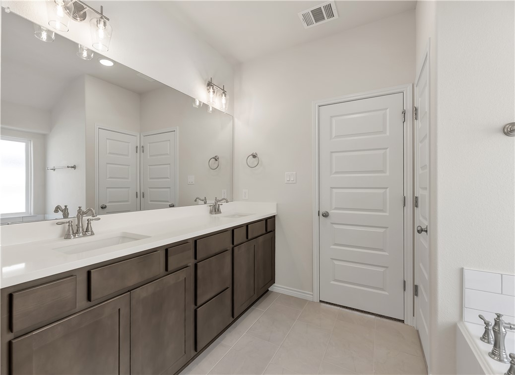 1931 Pinemont View Drive Bryan, TX 77807 - Photo 25 of 43 a bathroom with a double vanity sink and mirror